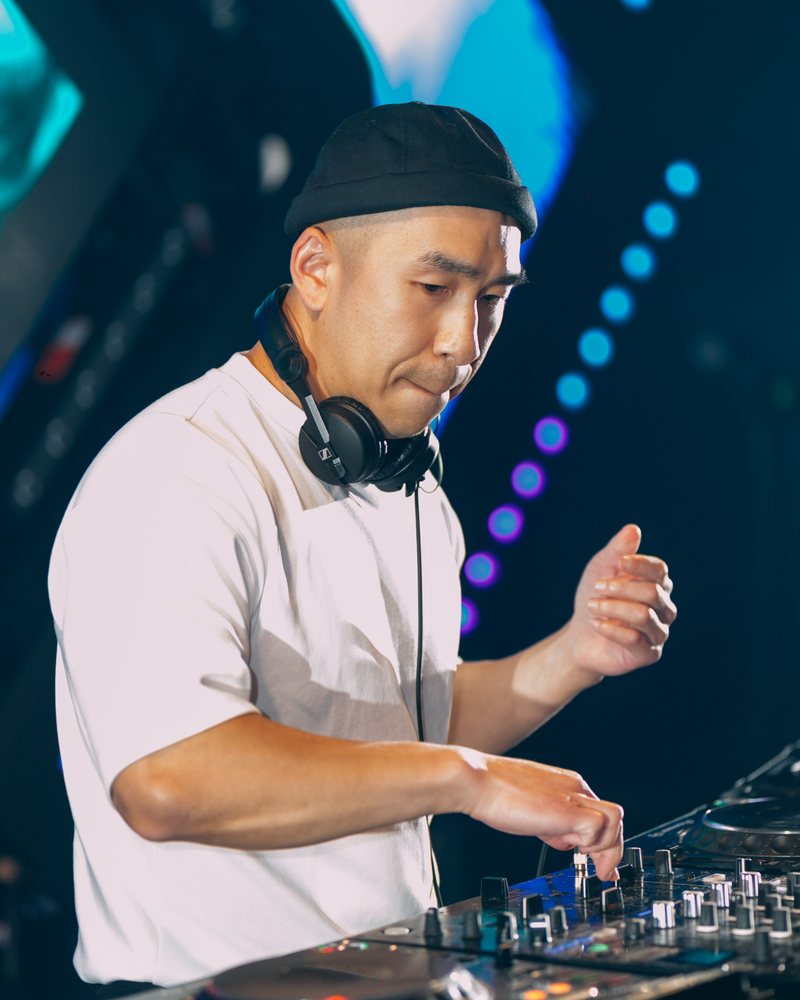 DJ Ken mixing on Pioneer decks in front of an LED screen