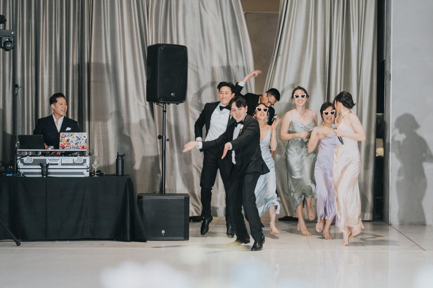 Bridal party dancing beside the DJ booth