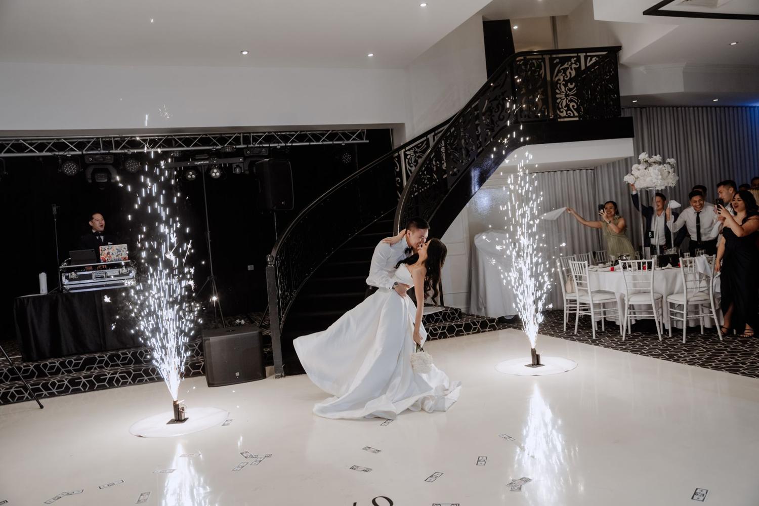Couple's first dance between cold sparkler fountains