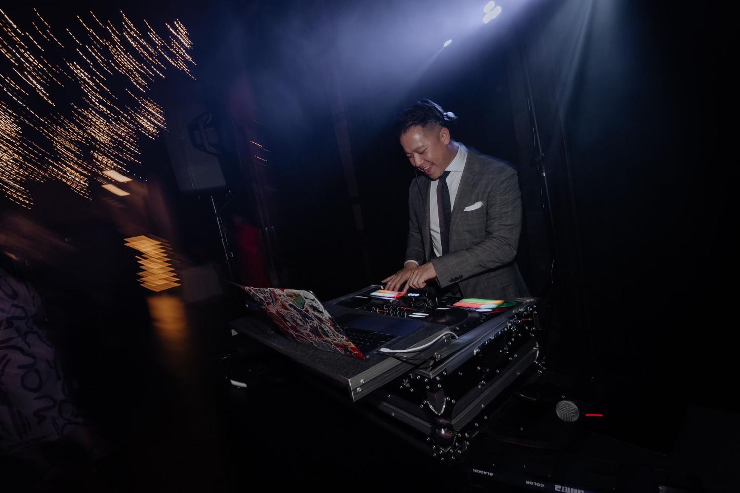 DJ under a spotlight at the decks